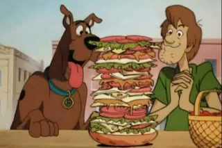 If cartoons have taught us anything, it’s that dogs love sandwiches bigger than their heads.